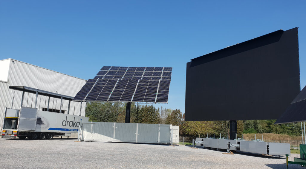 a press lory, mobile solar panel container and mobile ledscreen on the lot of Creacar
