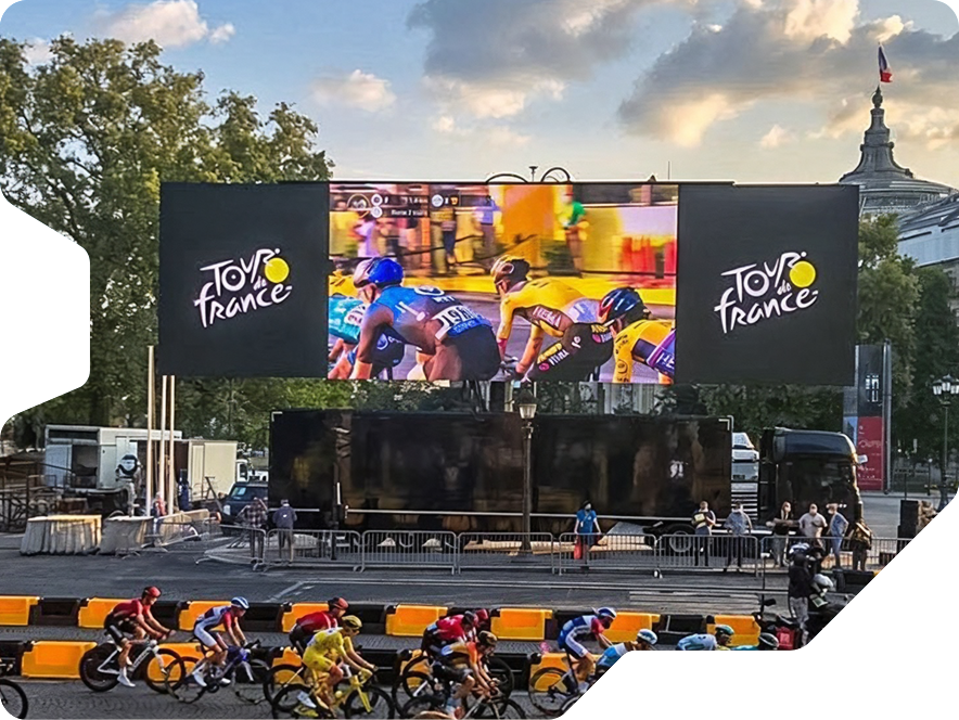 The ultra wide mobile LED screen by Creacar in use at the Tour de France. Showing Video image of the race while the racers ride by.