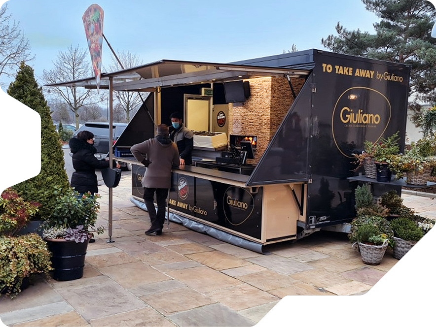 A creative food truck trailer with a fully functional pizza oven inside(!)