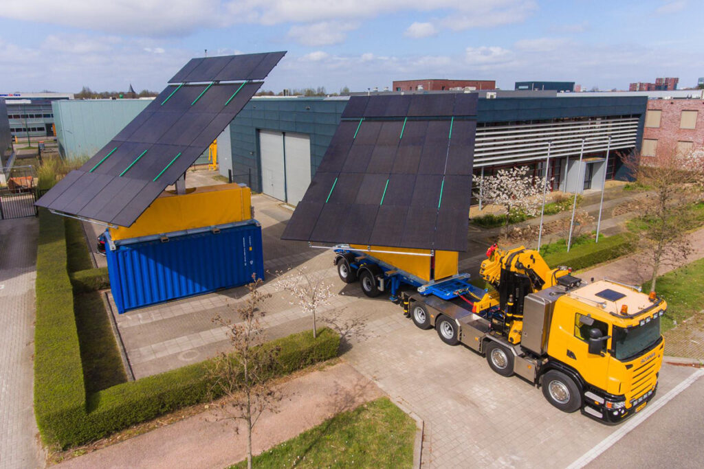 2 Creacar 20ft mobile solar panel containers on the back of a lorry - opened for power collection
