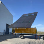 an opened solar panel container (20ft) ready for power generation