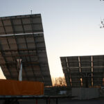 2 opened 20ft solar panel containers seen from the back at dusk
