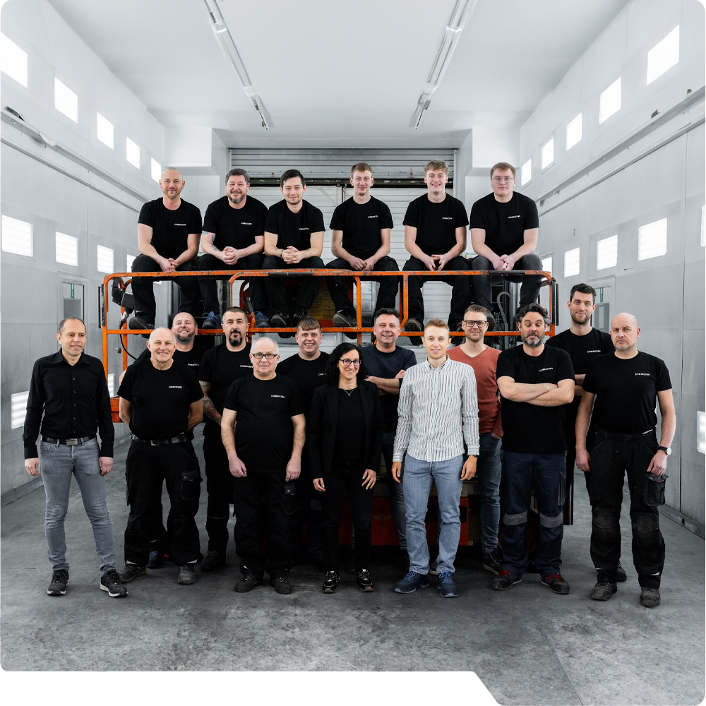 The creative and innovative team of Creacar standing in their paint facility
