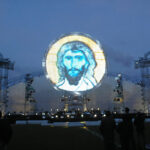 a custom stage led screen construction resembling a big satellite dish showing an image of Jezus