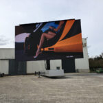 a rotatable mobile LED screen semi open trailer screen test at our manufacturing facility - woman in sports car on screen