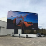 a rotatable mobile LED screen semi open trailer screen test at our manufacturing facility - woman and sports car on screen